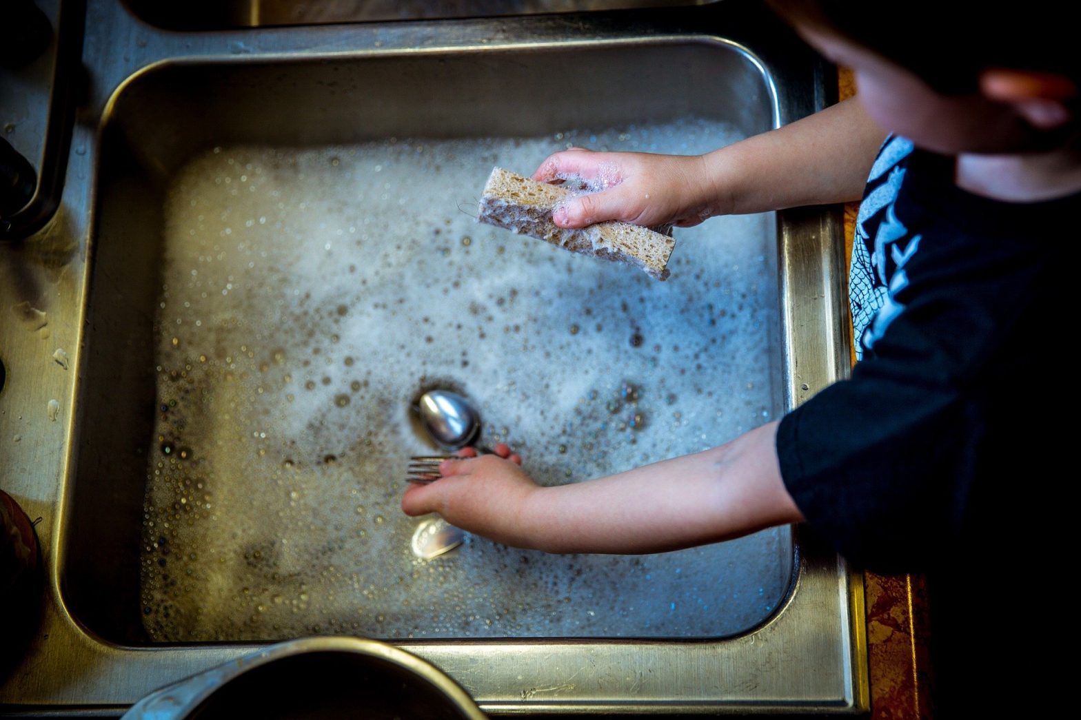 Young child washing up