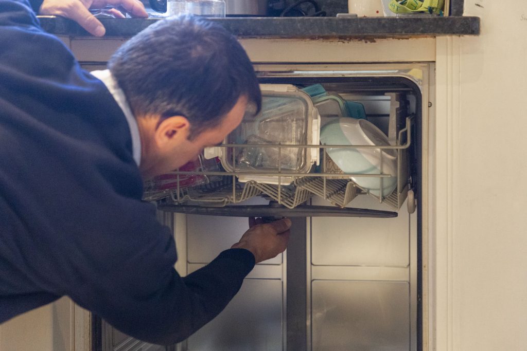 Domex engineer repairing dishwasher in Greenwich
